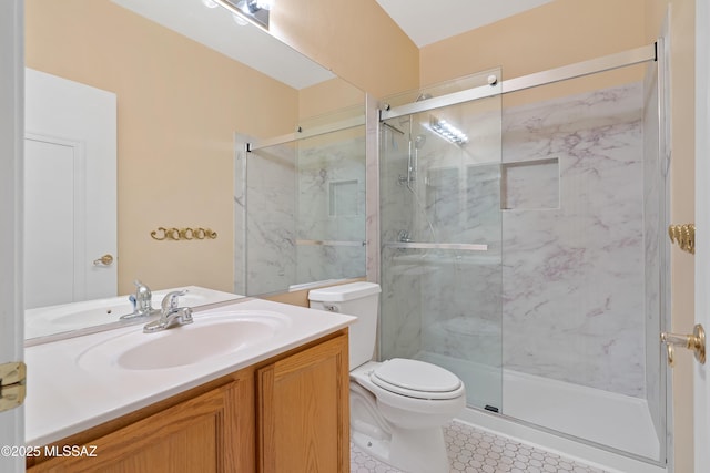 bathroom featuring vanity, toilet, tile patterned floors, and a shower with shower door