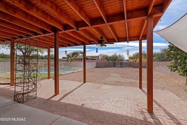 view of patio / terrace with a fenced in pool and ceiling fan