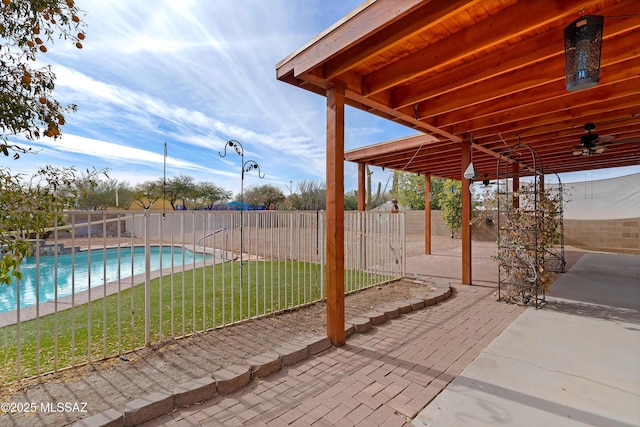 view of patio with a fenced in pool and ceiling fan