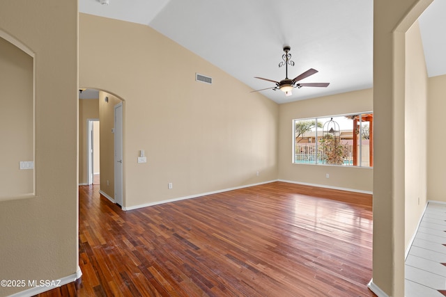 empty room featuring ceiling fan, dark hardwood / wood-style floors, and lofted ceiling