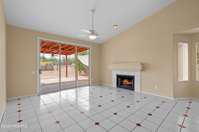 unfurnished living room with ceiling fan, a tiled fireplace, and light tile patterned flooring