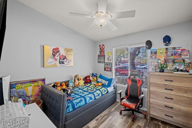 bedroom featuring ceiling fan, vaulted ceiling, and hardwood / wood-style flooring