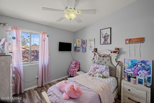 bedroom featuring ceiling fan, dark hardwood / wood-style floors, and vaulted ceiling