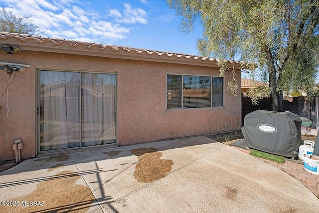 rear view of property featuring a patio area