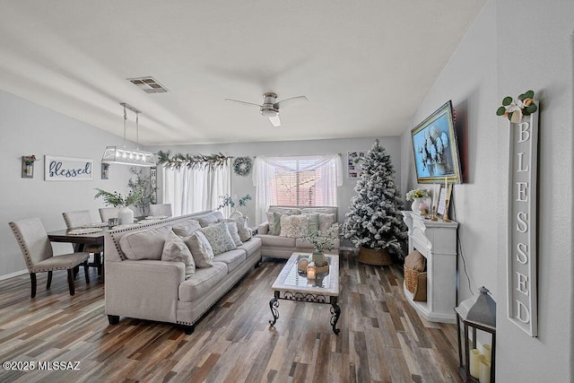 living room featuring ceiling fan, dark wood-type flooring, and lofted ceiling
