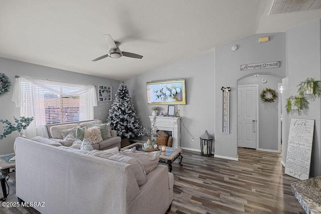 living room featuring ceiling fan, dark wood-type flooring, and lofted ceiling