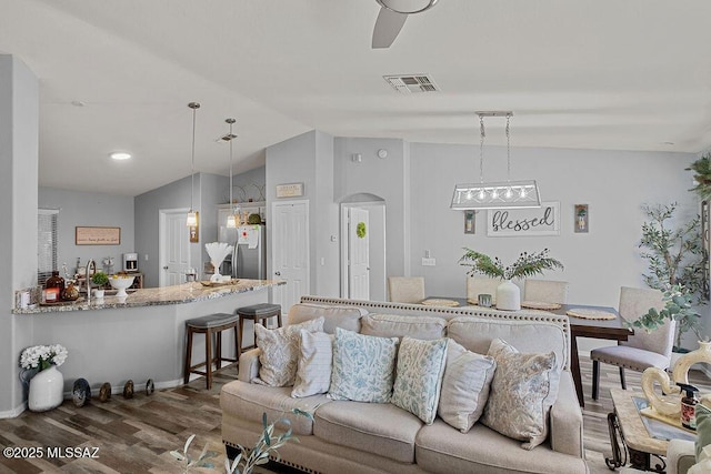 living room with dark wood-type flooring and vaulted ceiling