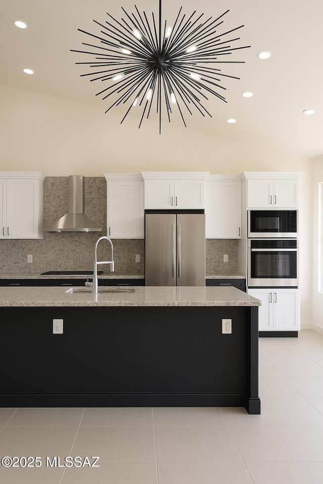 57 Highland Cir, Rio Rico, AZ 85648 - kitchen featuring high end refrigerator, wall chimney range hood, light tile patterned floors, white cabinetry, and recessed lighting