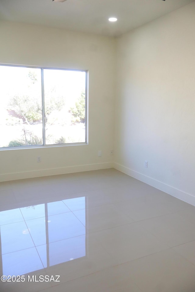 empty room with recessed lighting, baseboards, and tile patterned floors