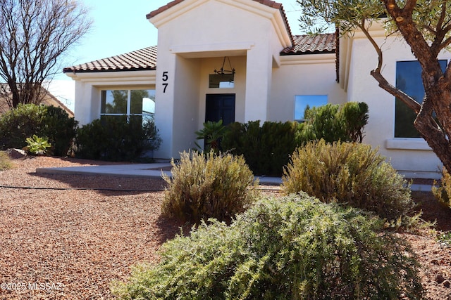 mediterranean / spanish-style home featuring a tile roof and stucco siding