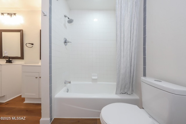 full bathroom with hardwood / wood-style flooring, vanity, toilet, and shower / bath combination with curtain