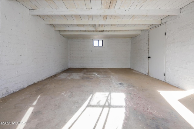 basement with brick wall and wooden ceiling