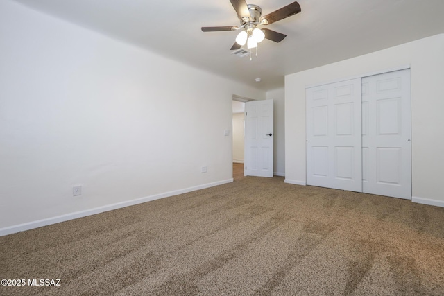 unfurnished bedroom with ceiling fan, carpet, and a closet