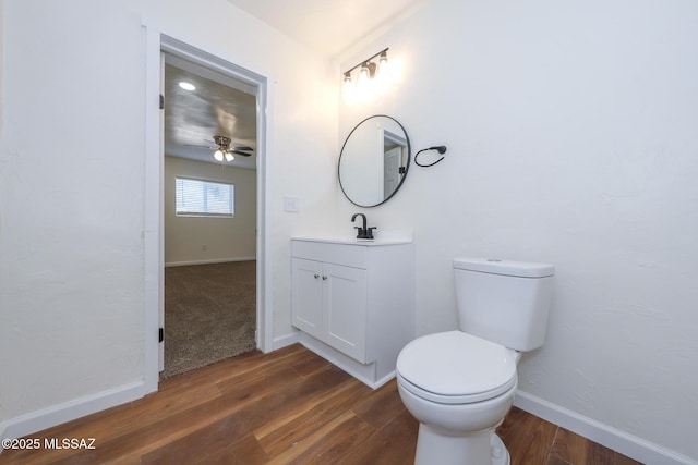 bathroom with vanity, hardwood / wood-style floors, and toilet