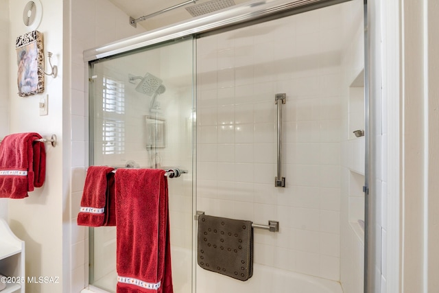 bathroom with a shower with door