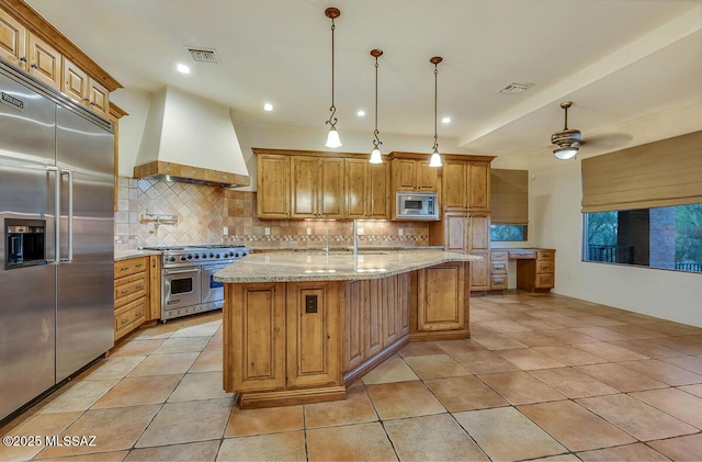 kitchen with built in appliances, premium range hood, decorative backsplash, light stone countertops, and recessed lighting