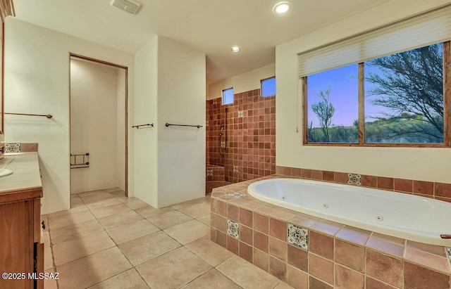 bathroom with a jetted tub, tile patterned flooring, vanity, tiled shower, and recessed lighting