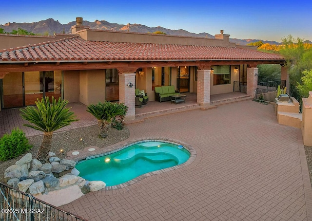 view of pool with a mountain view and a patio