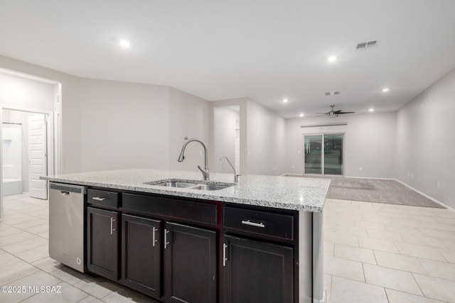 kitchen with light tile patterned flooring, sink, dishwasher, ceiling fan, and a kitchen island with sink