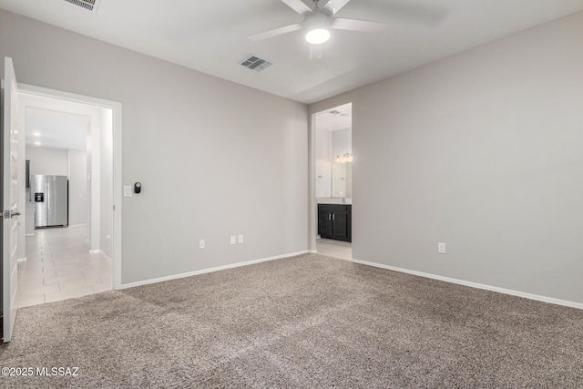 empty room featuring light colored carpet and ceiling fan