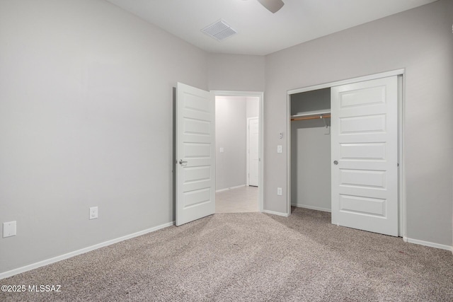 unfurnished bedroom with light carpet, a closet, and ceiling fan