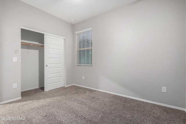 unfurnished bedroom featuring carpet and a closet