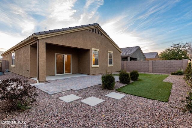 rear view of property featuring a patio