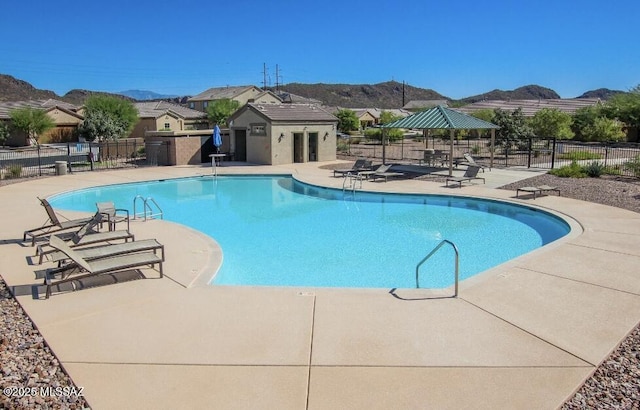 view of swimming pool featuring a mountain view and a patio area