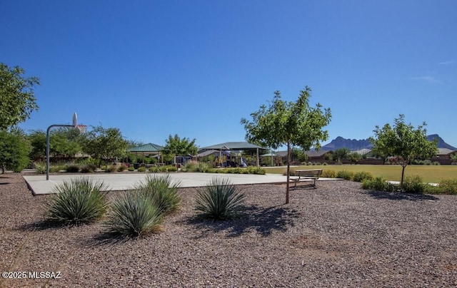 view of yard with a gazebo, a mountain view, and basketball court