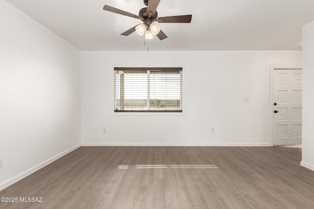 unfurnished room featuring hardwood / wood-style floors and ceiling fan