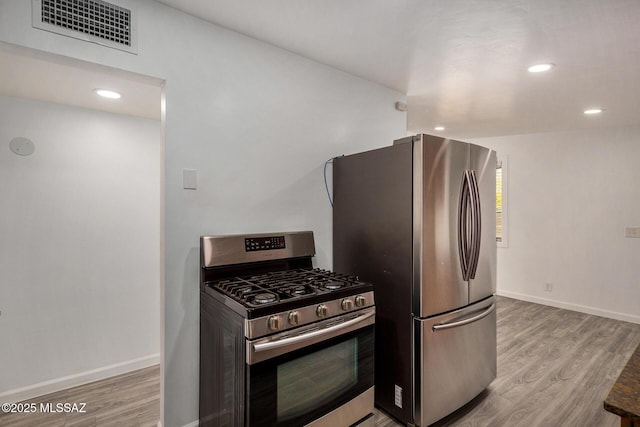 kitchen featuring appliances with stainless steel finishes and light hardwood / wood-style floors