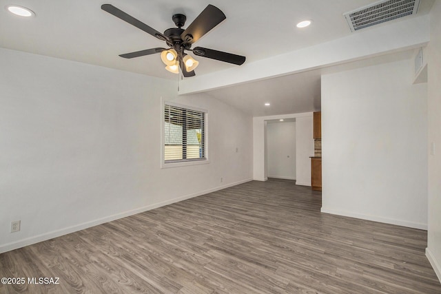 unfurnished room featuring hardwood / wood-style flooring, ceiling fan, and vaulted ceiling with beams