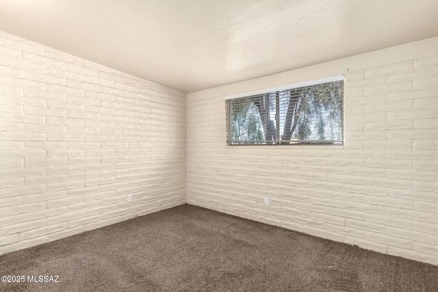 carpeted spare room with lofted ceiling