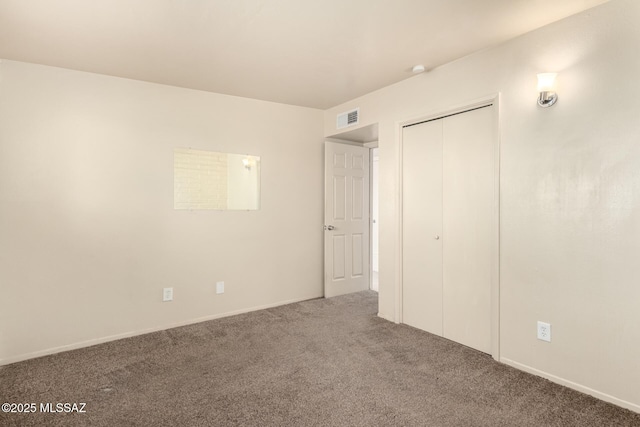 unfurnished bedroom featuring carpet floors and a closet