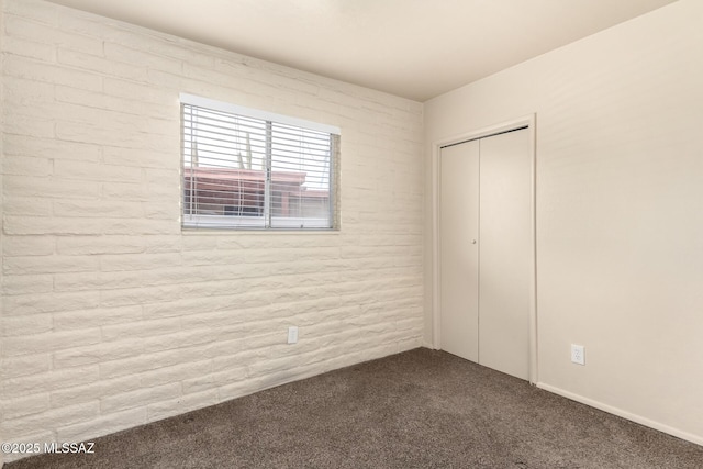 unfurnished bedroom with a closet and carpet floors