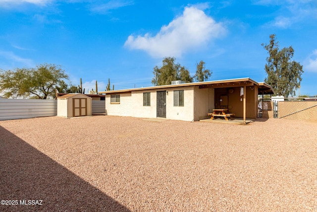 back of property featuring a patio area, cooling unit, and a storage shed