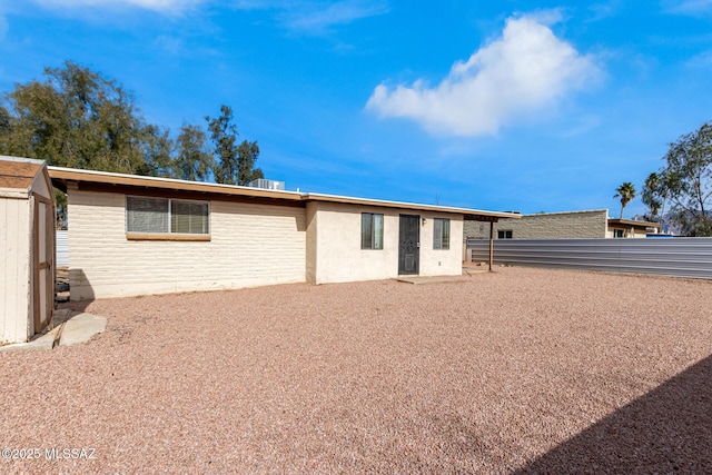 rear view of property featuring central air condition unit