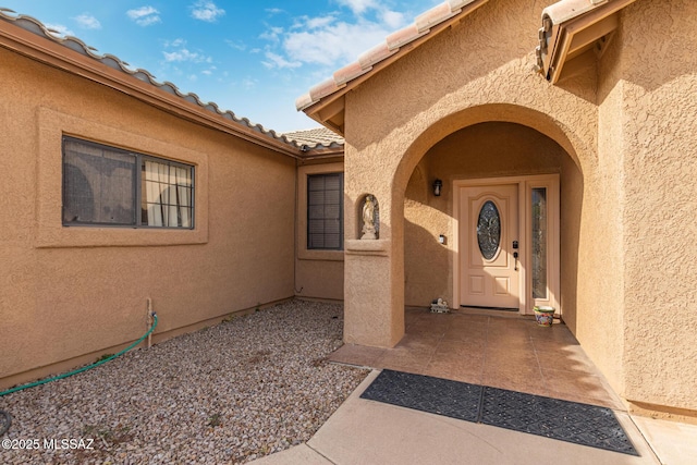 entrance to property featuring a patio area