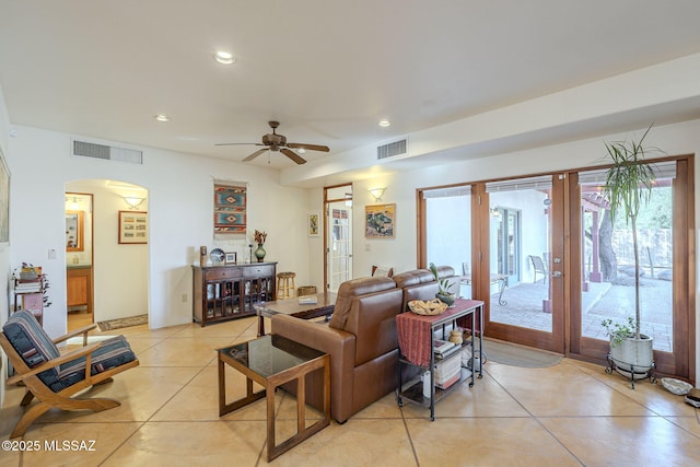 tiled living room featuring french doors and ceiling fan