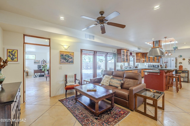 living room with light tile patterned floors and ceiling fan