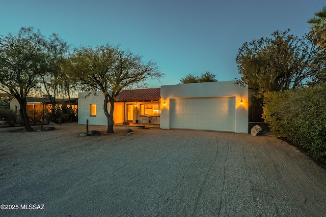 pueblo revival-style home with a garage