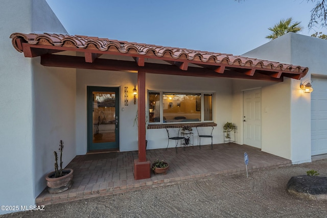 exterior entry at dusk with a garage