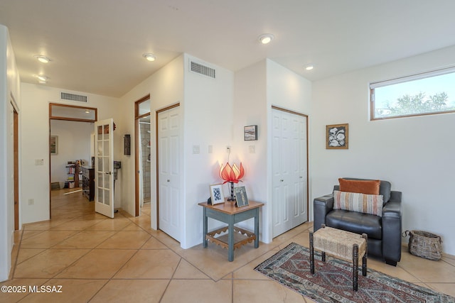 interior space featuring light tile patterned floors and french doors