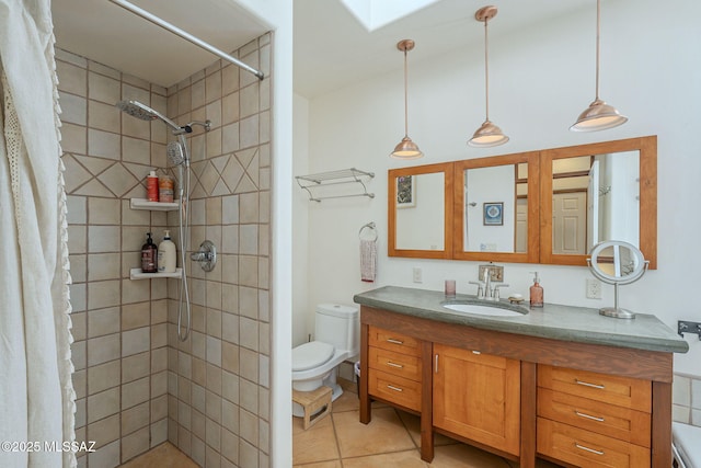 bathroom with tile patterned flooring, a skylight, vanity, a shower with curtain, and toilet