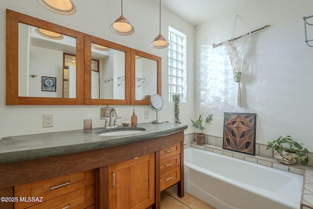 bathroom with vanity, a bath, and tile patterned floors