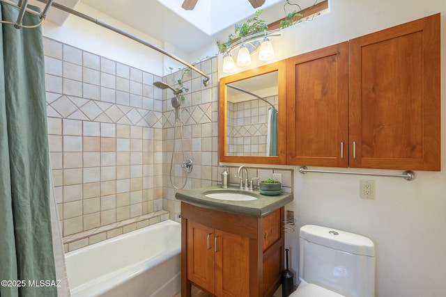 full bathroom featuring ceiling fan, vanity, toilet, and shower / tub combo