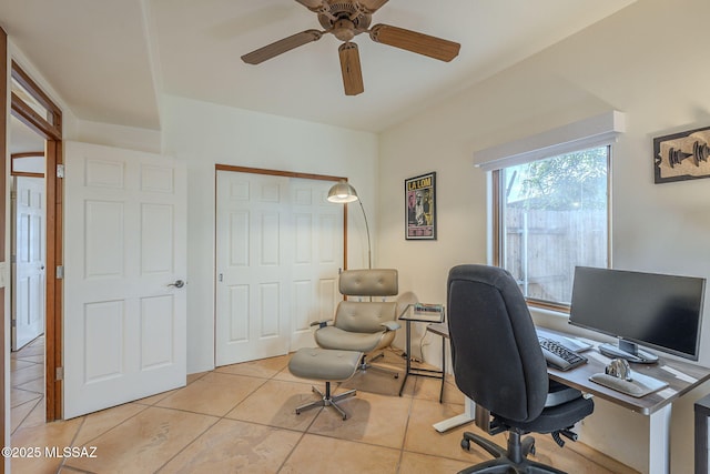 home office with light tile patterned floors and ceiling fan