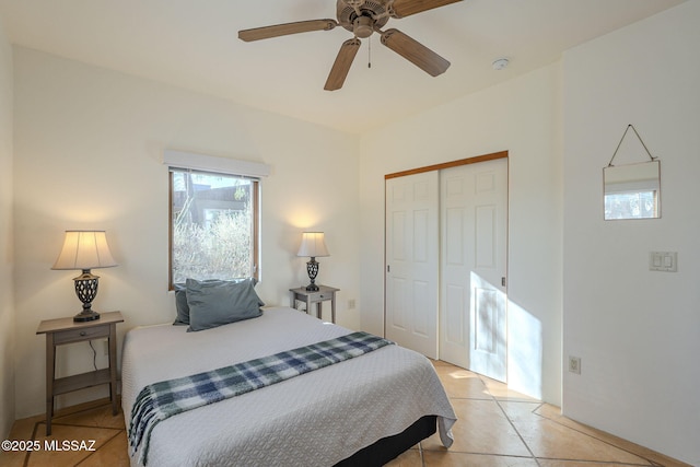 bedroom featuring a closet, ceiling fan, and light tile patterned flooring