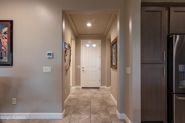 doorway to outside with light tile patterned floors