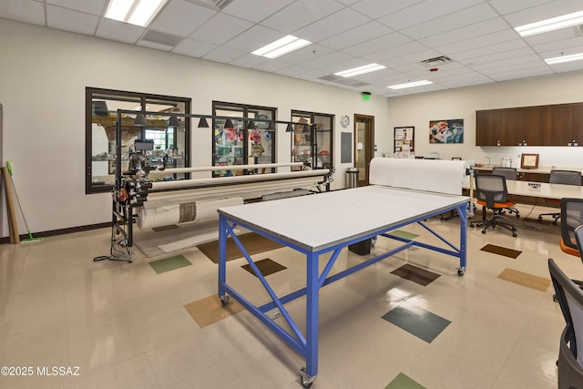 gym with a paneled ceiling